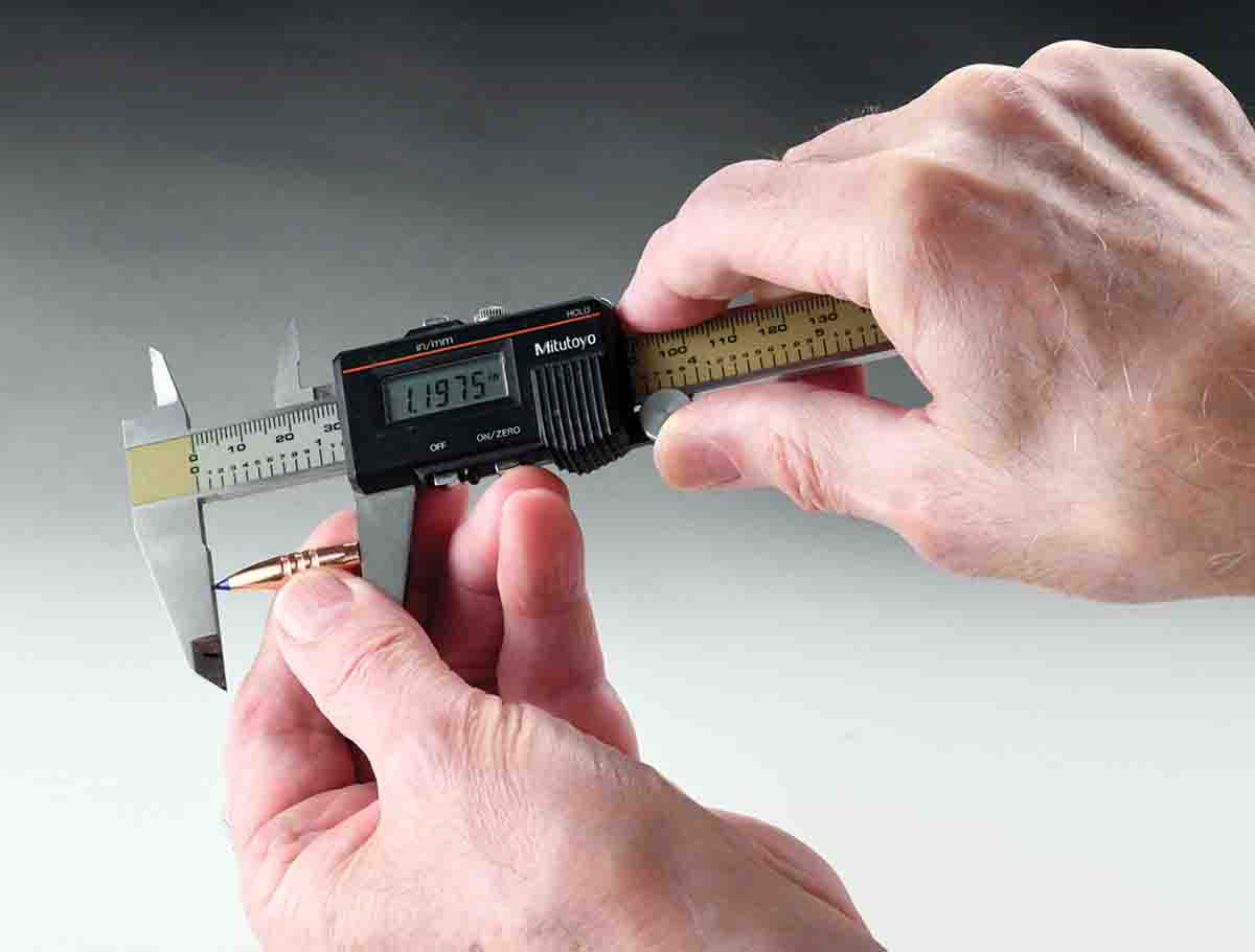 Today’s bullets are more streamlined with a higher static ballistic coefficient. BC is degraded if a barrel’s twist rate does not provide the proper RPMs to stabilize the chosen bullet. This is a Barnes 100-grain TTSX BT being measured for length.